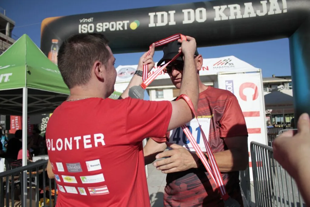 A participant receiving a medal at the 2025 finish area